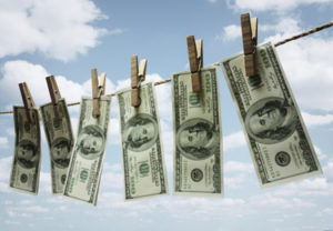 Hundred dollar bills hanging from a clothesline concept for money laundering, investment or venture capital funding