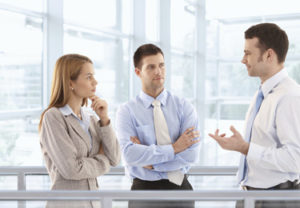 Businesspeople chatting in modern office lobby