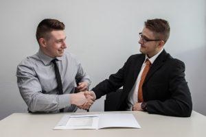 A man shaking hands with his employee